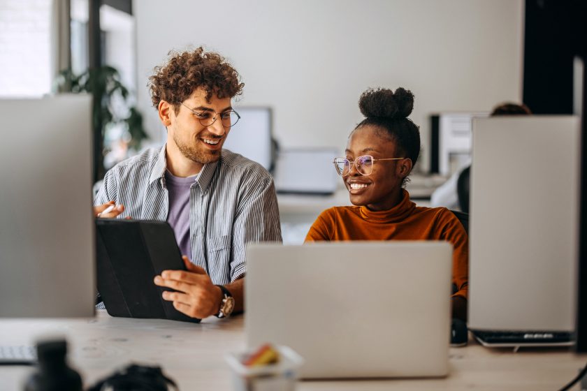 Two young colleagues working together at modern office